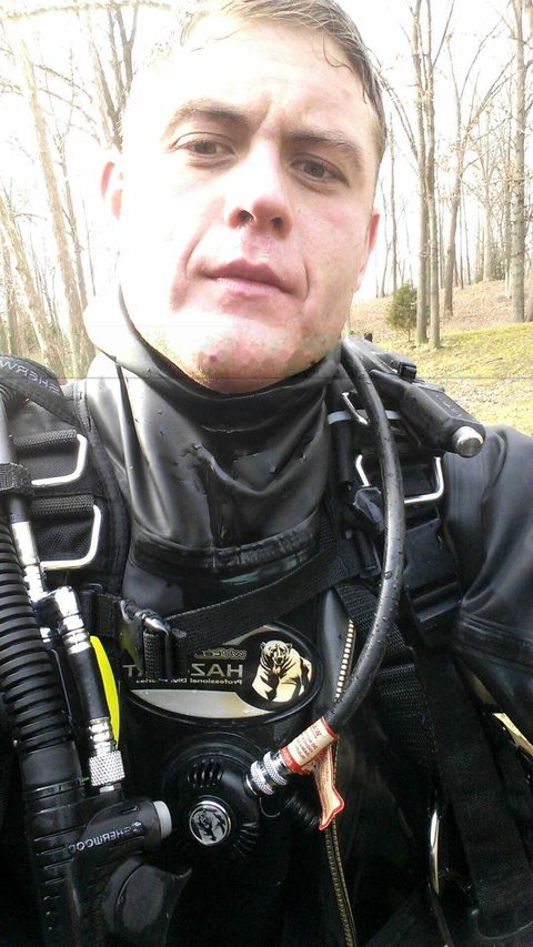 Cody Rose in a dry suit and full dive rig before a winter dive.