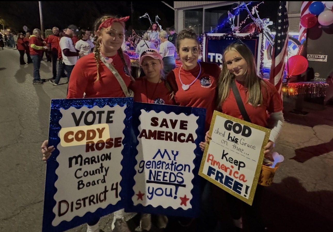 Young supporters holding handmade signs reading Vote Cody Rose, Marion County Board District 4.