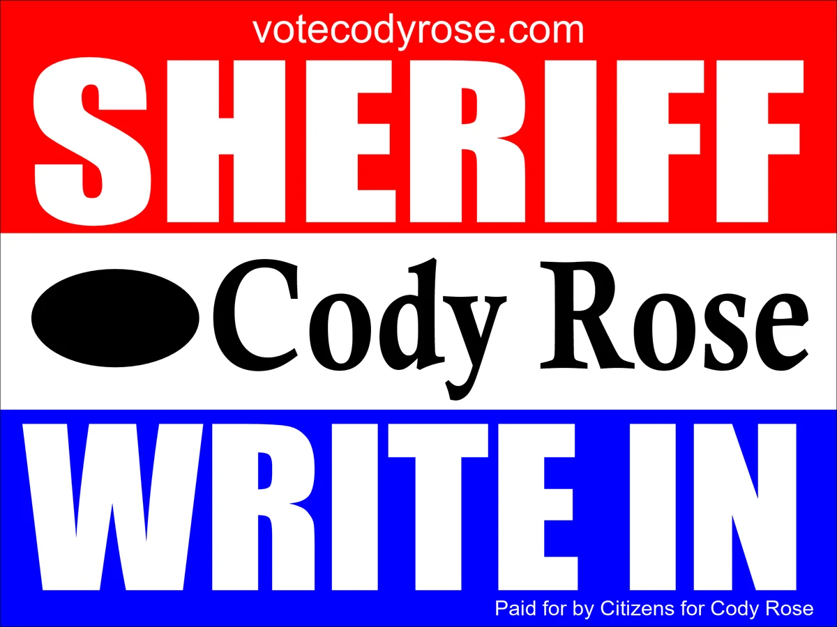 Cody Rose yard sign: red band reading SHERIFF with votecodyrose.com, white band with a filled oval next to the name Cody Rose, blue band reading WRITE IN. Paid for by Citizens for Cody Rose.