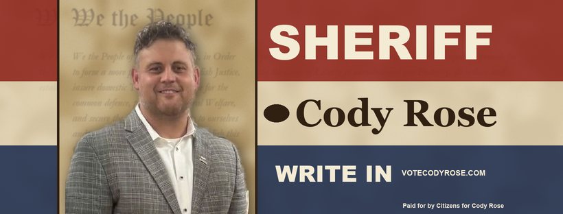 Campaign banner: Cody Rose against the Preamble to the Constitution, on red, cream and navy stripes, reading Sheriff, Cody Rose, Write In, votecodyrose.com.